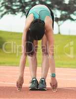 Always be sure to stretch. Full length shot of an unrecognizable young sportswoman stretching on a running track.