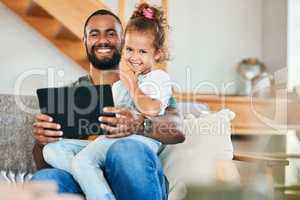 Discovering tons of educational videos and app for his little one. Portrait of a father and his little daughter using a digital tablet together at home.