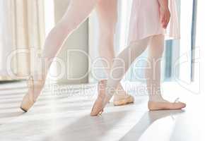 Ballet is ultimately a logical technique. a group of unrecognizable ballet dancers during their rehearsal in a studio.