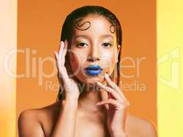 Why fit in when you were born to stand out. Studio shot of a beautiful young woman wearing blue lipstick.