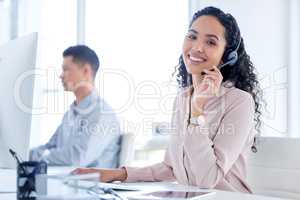 Were always happy to assist. a young call centre agent sitting with her colleague and using her computer.