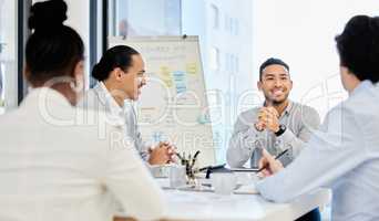 Teamwork to the rescue. businesspeople having a meeting in a boardroom at work.