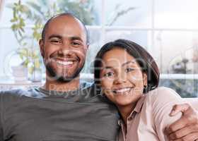 Being together is the best blessing for us. Portrait of a happy young couple relaxing together at home.