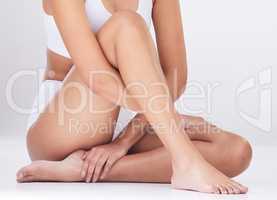 Perfect skin. Studio shot of an unrecognizable womans legs against a grey background.