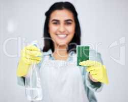 Lets make this place brand new again. Closeup shot of a woman holding up a spray bottle and sponge.
