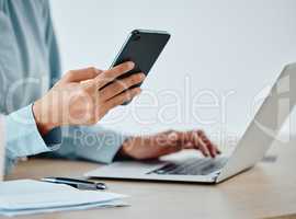Modern businesswoman texting on phone and laptop while working, reading and planning strategy indoors. Closeup of a productive corporate worker multitasking on multimedia technology and app software