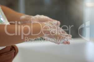 Clean and protection from infection by a young girl washing her hands with foam soap in the bathroom for virus prevention. A child practicing hygiene and cleanliness by rinsing her palms in the sink