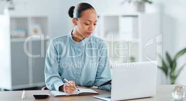 Busy, smart and serious business manager with a laptop working on schedule, planning and brainstorming ideas inside office. Lady marketing analyst writing strategy for project plan in her diary