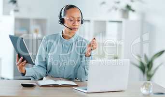 Serious and confident call center agent calling, helping and assisting a deal or sale on laptop and tablet. Focused, successful and motivated freelance support staff multitasking to help customer