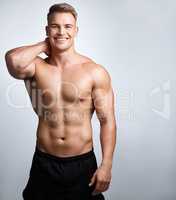 Life is too short not to make gains. Studio portrait of a muscular young man posing against a grey background.