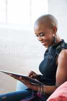 Bald african american woman using digital tablet computer at home