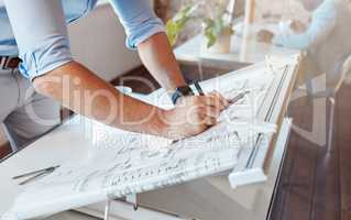 Architect drawing a plan for a building project inside his office. Closeup of a male engineer doing a blueprint sketch at an architecture company or his workplace. Housing planner making a diagram