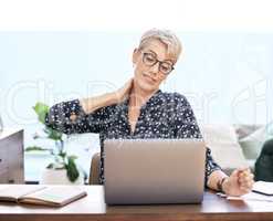 Maybe its time for a break. a mature woman sitting and suffering from a sore neck while using her laptop to work from home.