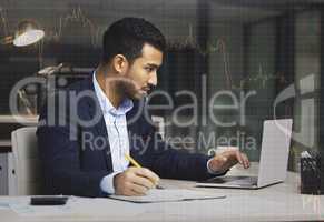 Stressed businessman using a laptop, trading on the stock market in a financial crisis. Trader working online with a computer in a bear market. Market crash and economy depression or failure