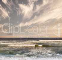 Colorful sky, sea waves and beautiful beach view with tides and currents under a natural horizon on a cold morning with copy space. A quiet and serene ocean scene in nature during the evening