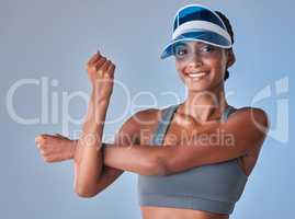 The healthiest choices create the happiest life. Studio shot of a fit young woman stretching against a grey background.