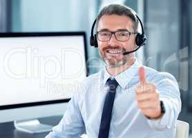 Ill be happy to help. Portrait of a call centre agent showing thumbs up while sitting at his desk.