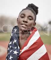 Taking a chance on myself. a beautiful young female athlete with the american flag wrapped around herself.