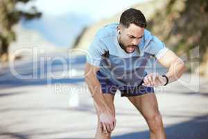 If you believe and work for it, youll achieve unbeatable results. a sporty young man checking his wristwatch while exercising outdoors.