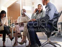 Meetings make us successful. a diverse group of businesspeople sitting in the boardroom during a meeting.