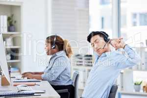 Stretching, stressed and tired call centre agent suffering from burnout, backache or being overworked. Lazy, bored and exhausted customer service representative feeling sleepy and listening to client