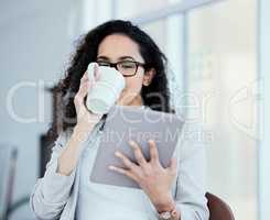 I wonder how I should respond to this email. a young businesswoman using her digital tablet while drinking coffee.