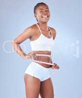 I feel joyful to look at how far Ive come. Studio shot of a young woman measuring her waist.