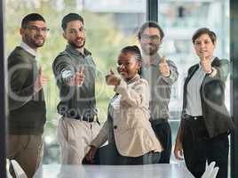 Are you ready for whats to come. Portrait of a group of businesspeople showing the thumbs up in a modern office.