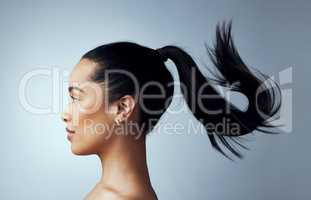 Life is too short to have boring hair. Studio shot of an attractive young woman posing against a grey background.