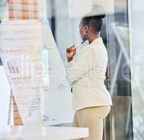 My neurons are firing at full speed. a young businessman preparing for a presentation while working on a whiteboard.