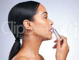 Cling to your inner Goddess. a beautiful young woman posing with her perfect shade of lipstick against a grey background.