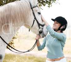 A horse has courage to guide men to the heavens. an attractive young woman standing with her horse in a forest.