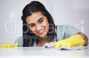 Nobody cleans like I do. a woman using a cloth while wiping a white counter.