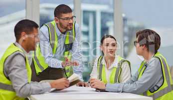 Theres no room for error in our industry. a group of young construction workers sitting around the boardroom table during a meeting.