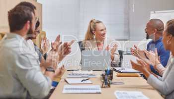 Applause all round. a group of corporate businesspeople applauding during a meeting in the boardroom.