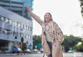 I hope Ill get to work on time. a young businesswoman hailing a cab in town.