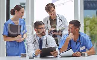 Working on healthcare matters with utmost dedication. a group of medical practitioners working together in a hospital boardroom.