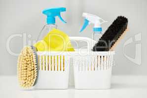 Well make your place sparkle. cleaning supplies in a basket on a table.