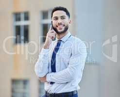 Lemme think about it and Ill call you back. a handsome young businessman making a phonecall while standing outside in the city.