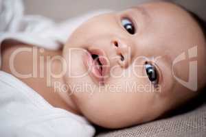 Hell melt your heart with his cuteness. Portrait of an adorable baby at home.