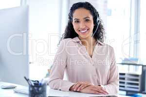 Next caller please. an attractive young call centre agent sitting alone in her office during the day.