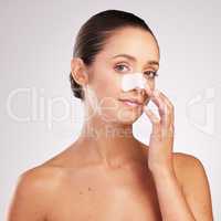 Blackheads dont go with my outfit. an attractive young woman wearing blackhead remover against a studio background.