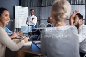 Her presentations make them curious to know more. a group of businesspeople in a meeting at work.