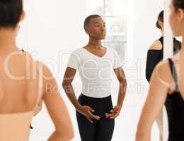 Dance is the hidden language of the soul. a group of ballet dancers practicing a routine in a dance studio.