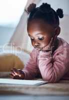 I wonder what Ill read today. a little girl using her digital tablet in her bedroom.