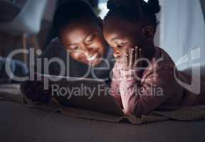 And then they lived happily ever after. a mother reading bedtime stories with her daughter on a digital tablet.