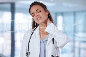 She has too much built up tension. a young female doctor suffering from neck pain at work.