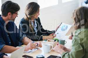 Young business woman holding document presenting financial data to colleagues in meeting brainstorming ideas using market research
