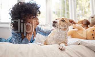 Manage your emotions and hang in there. an adorable young boy playing with his dog in his bedroom at home.