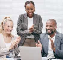 Showing their appreciation. a group of white collar businesspeople clapping while gathered around a laptop in the boardroom.